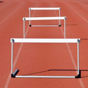 hurdles on red rubber track